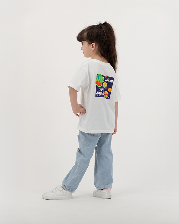 Kid in white Batikh T-Shirt showcasing fruit-themed print.