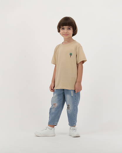 Boy wearing The Palm Kids Leaf Print Tee with desert palm design.