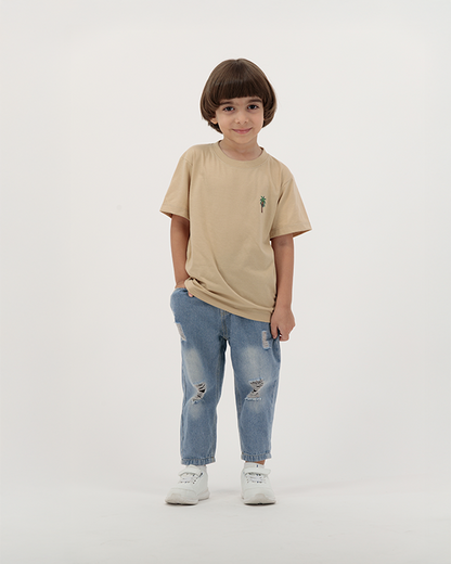 Child boy wearing beige palm tree print T-shirt from The Palm Kids collection.