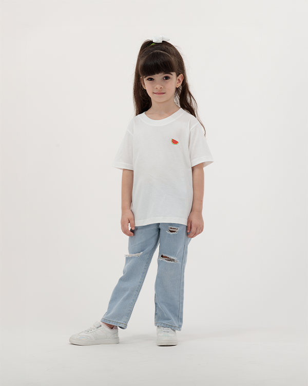Girl wearing white Batikh Watermelon Print Kids T-Shirt with fruit graphic on back.