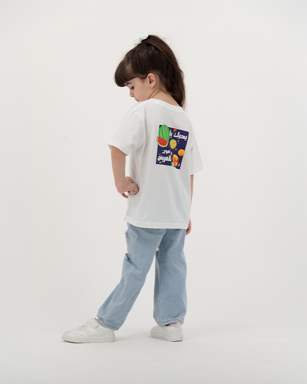 Little girl wearing Batikh Kids T-Shirt with watermelon print on back.