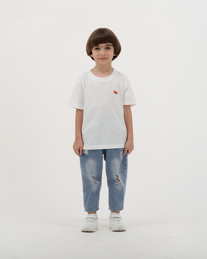 Boy wearing white Batikh Watermelon Print Kids T-Shirt with fruit design on back.