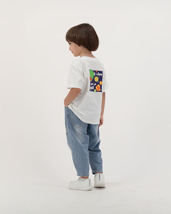Kid boy wearing Batikh Watermelon Print Tee with colorful fruit artwork.