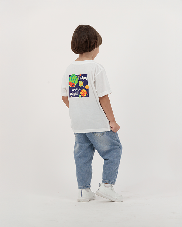 Boy modeling Batikh Kids T-Shirt with watermelon and fruit design.