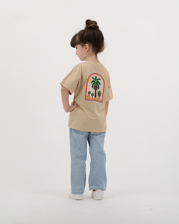 Kid girl wearing The Palm Kids T-Shirt with palm and sun design.