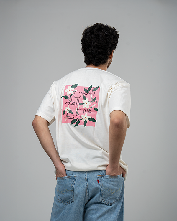 Man wearing Jasmine White Oversized T-Shirt with floral print on back.
