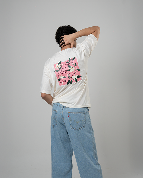 Model wearing Jasmine Oversized Tee with jasmine flower graphic.
