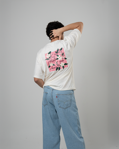 Model wearing Jasmine Oversized Tee with jasmine flower graphic.